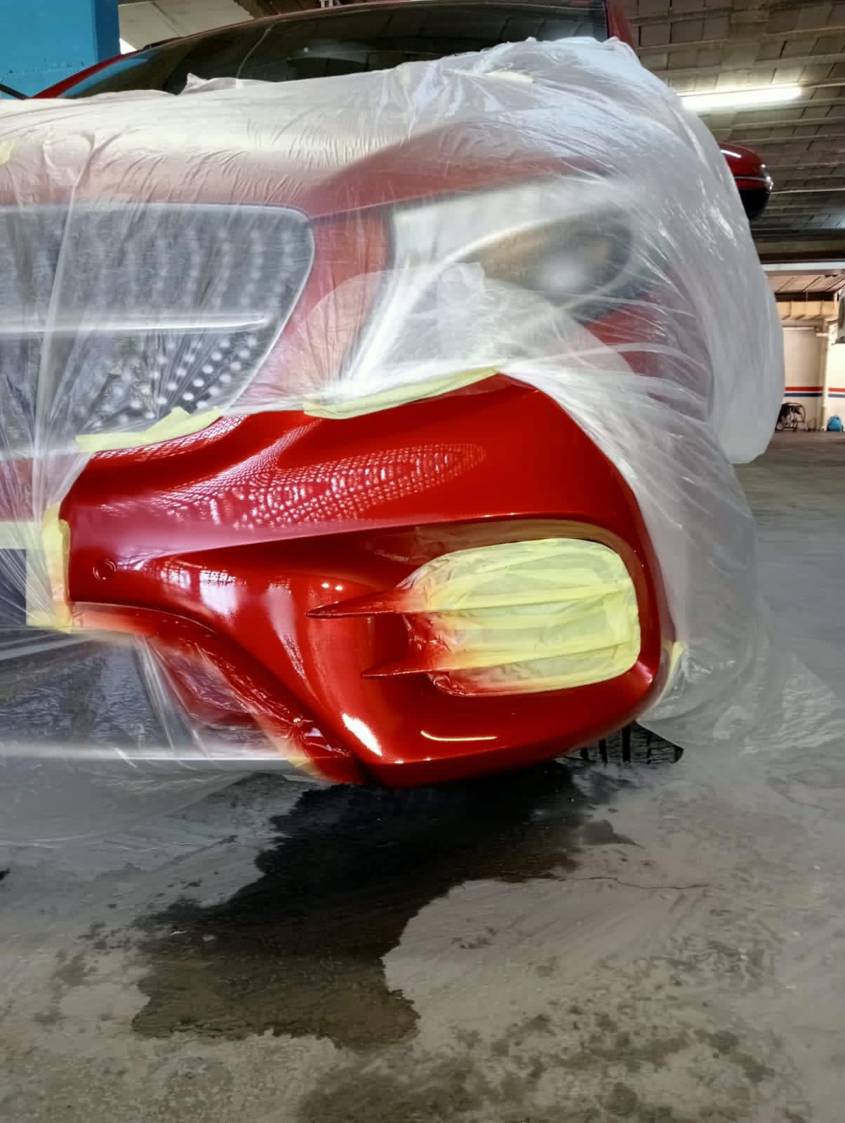 Technician completing vehicle paint repair work